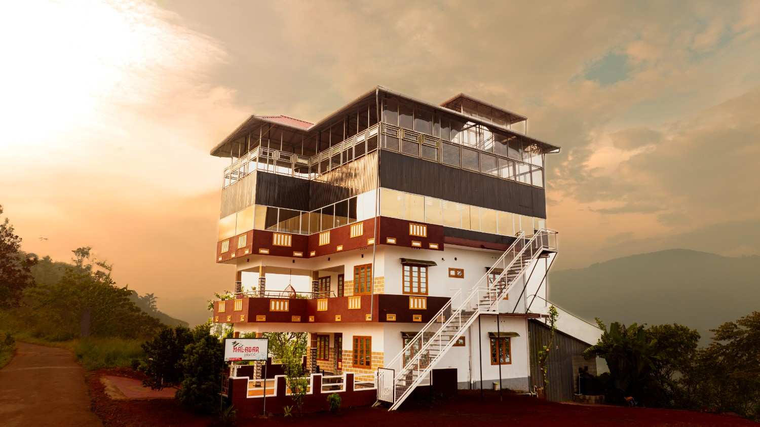 Malabar House Homestay building surrounded by the hills of Idukki